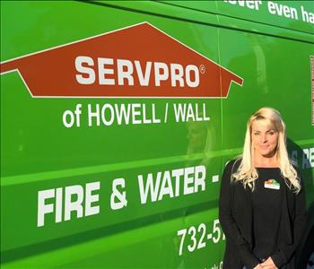 photo of crew member - Renee, female standing by green SERVPRO vehicle