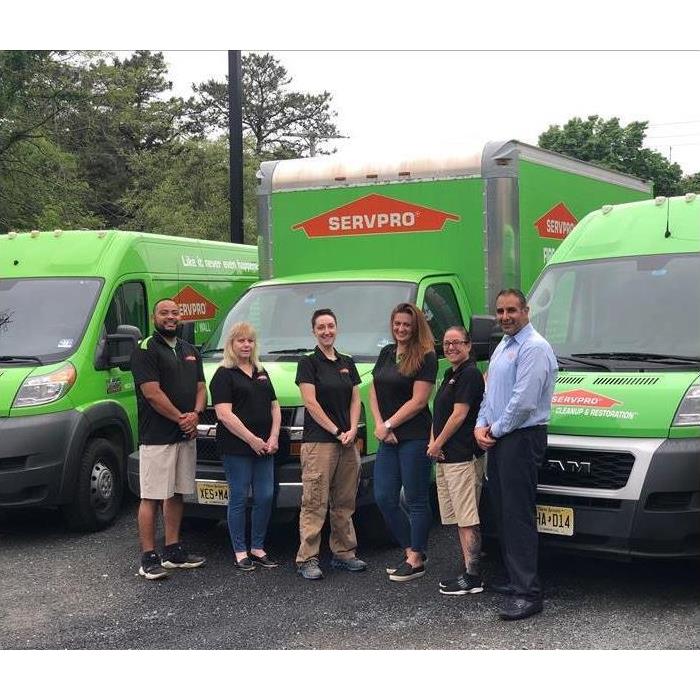 SERVPRO of Howell/Wall group in front of SERVPRO vehicles